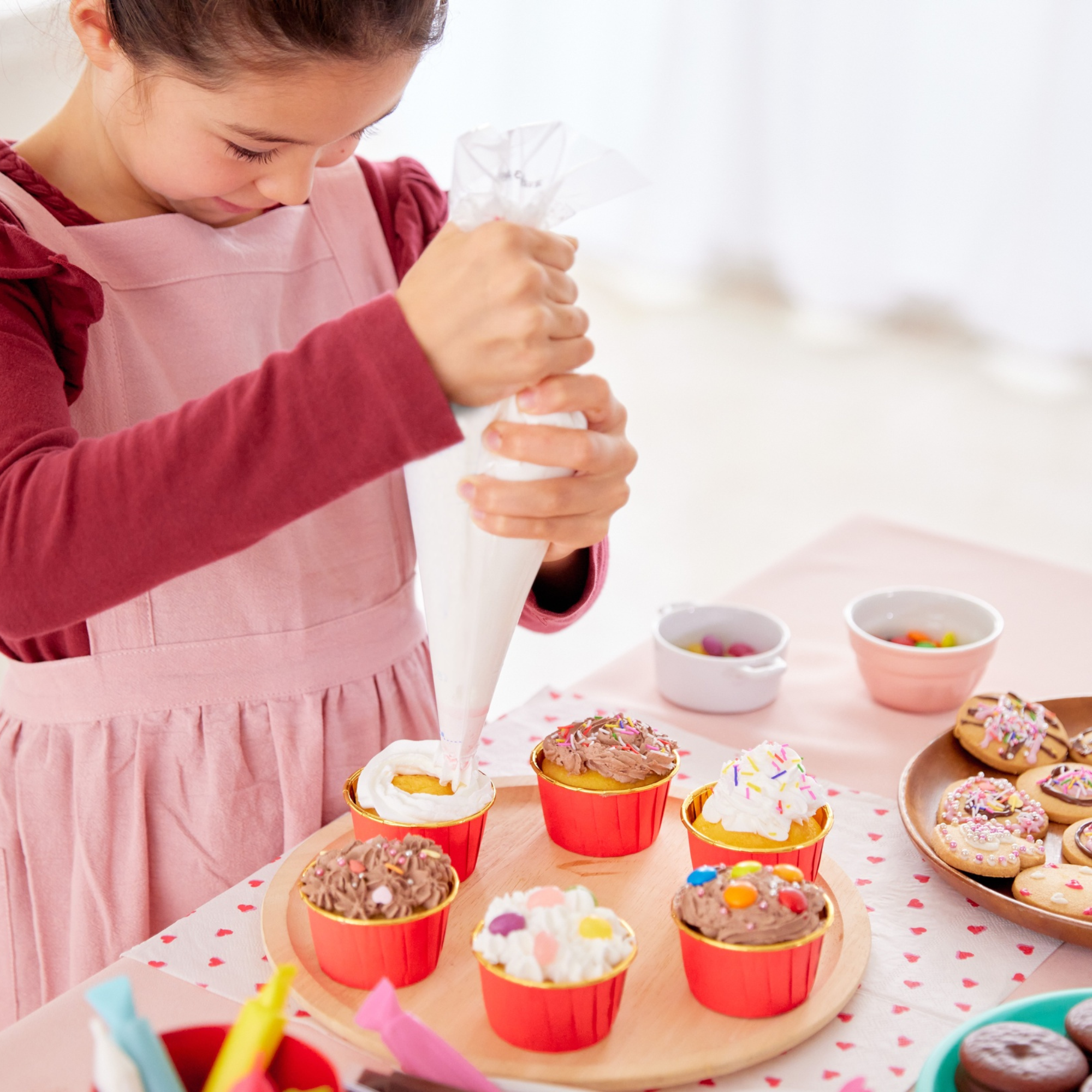 Girl decorating fall themed cupcakes