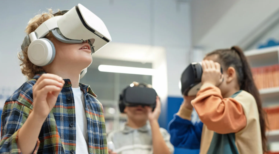 Kids playing with VR headsets. 