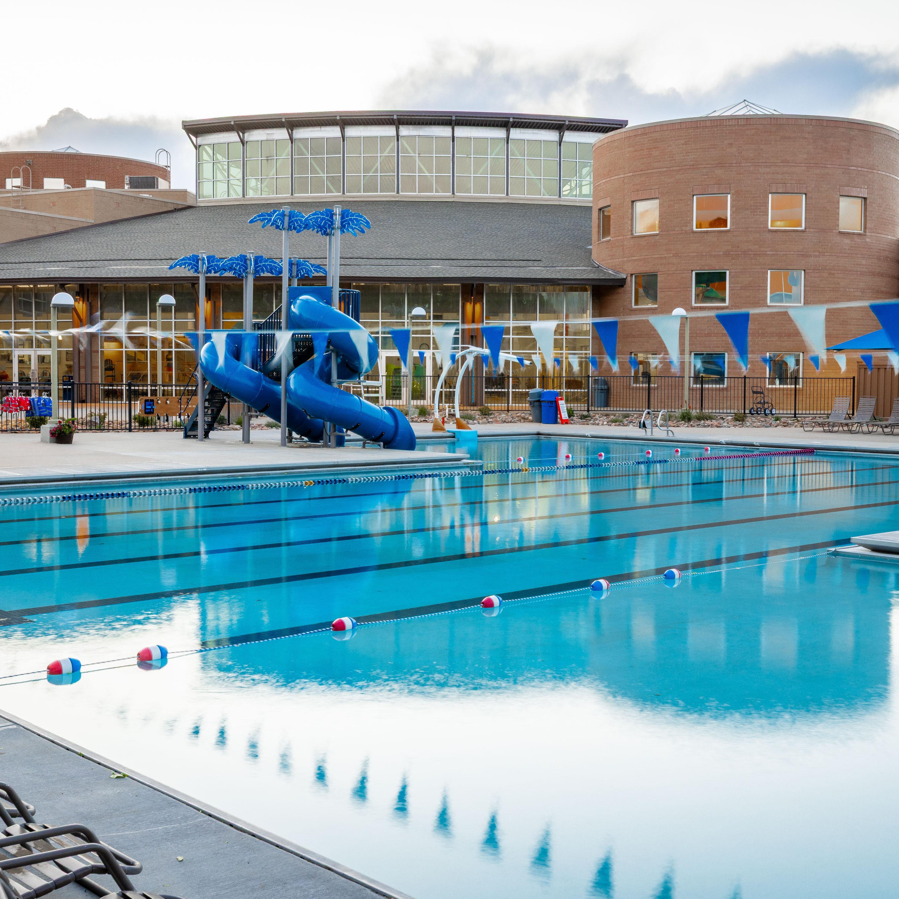 Photo of outdoor pools and outside of recreation center. 