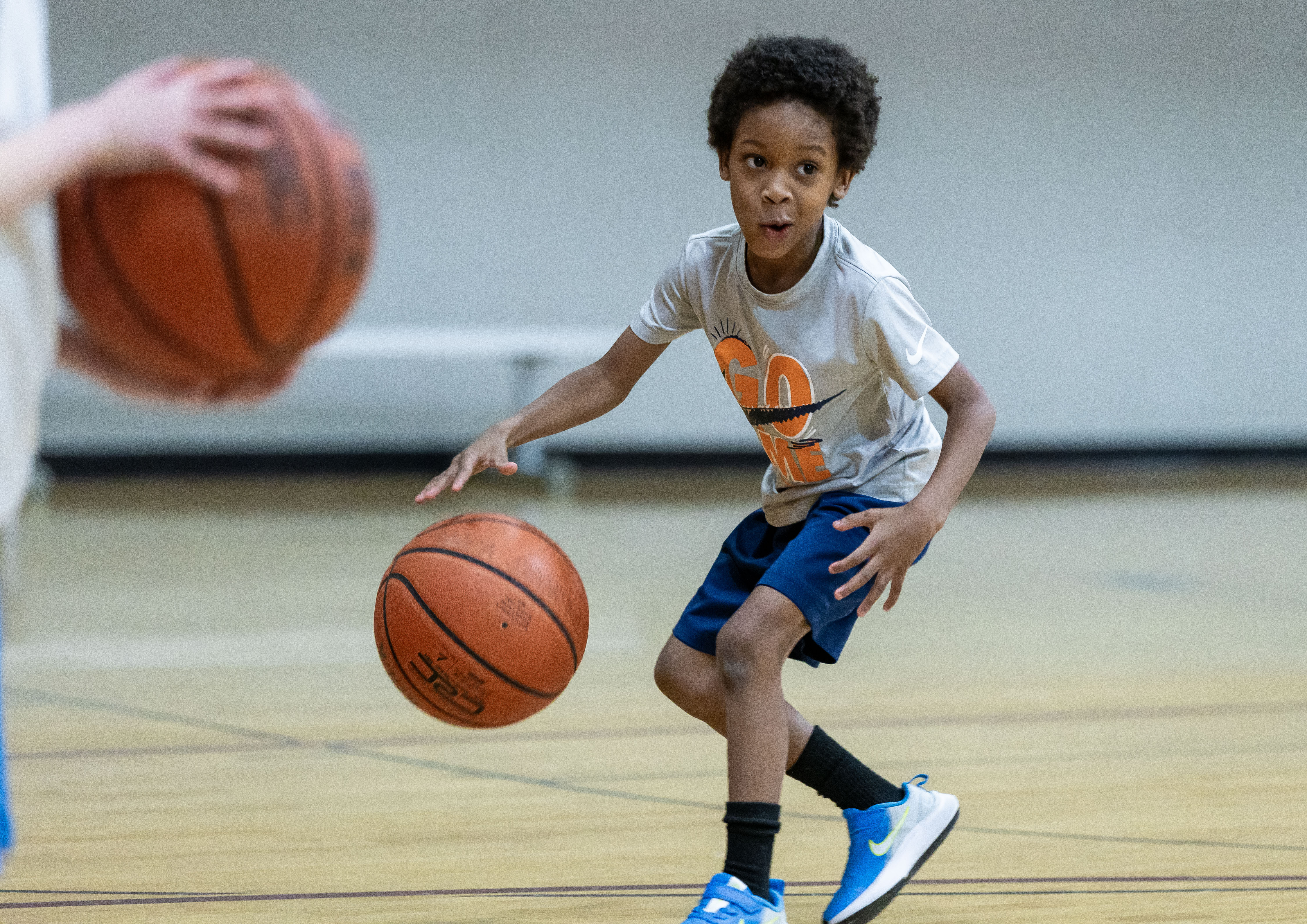 Little boy dribbling basketball. 