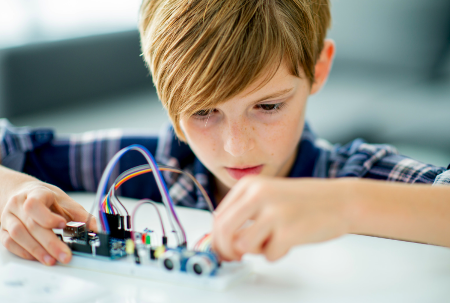 Boy building electic circuit.